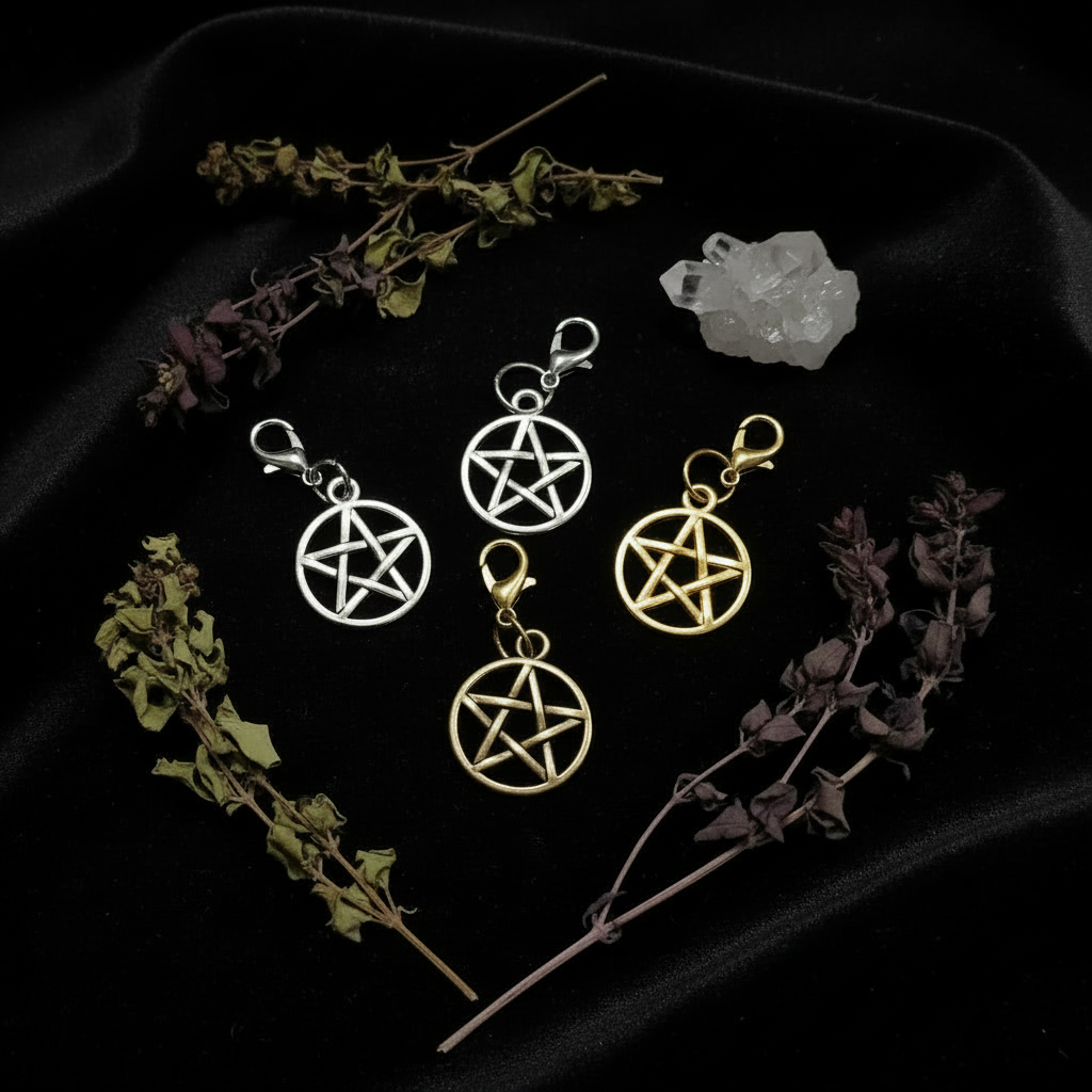 Pentagram stitch markers in silver, gold and bronze on black velvet with crystals and dried herbs